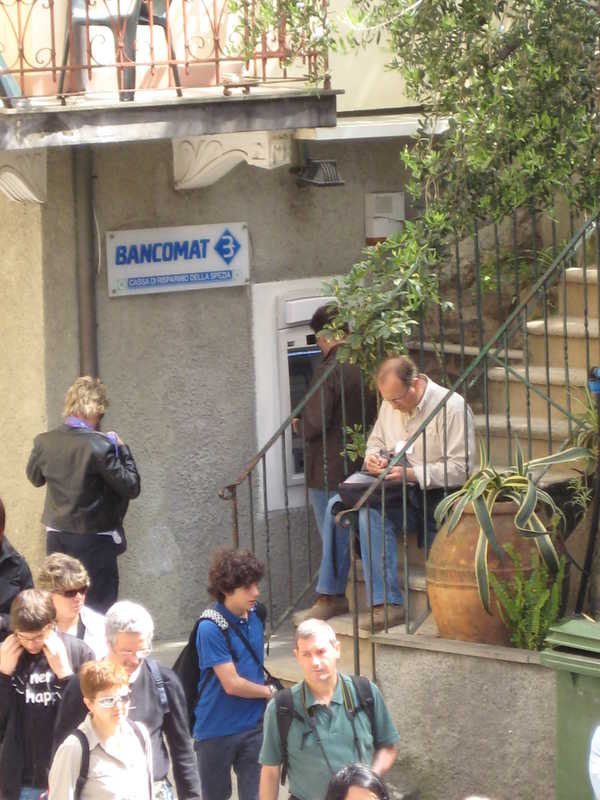 Mico tracking notes in front of Carispe ATM